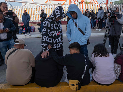 Asylum seekers wait for news on their CBP One appointments with US authorities as they expect to cross to the US, at El Chaparral port in Tijuana, Baja California state, Mexico, on January 20, 2025.  