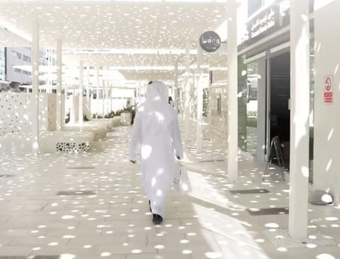 The walkway includes retail outlets, cafés, and outdoor seating areas that are designed for use throughout the year.