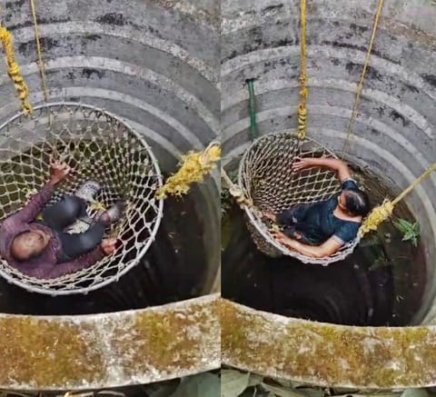 A 64-year-old man and his wife being lifted from a well by Fire Force Rescue officers in Kerala.