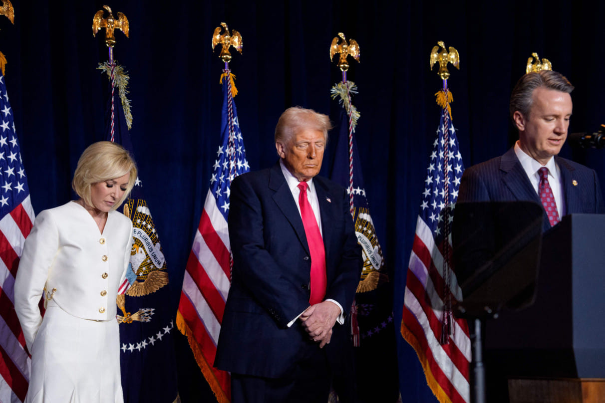 From left: Televangelist Paula White and US President Donald Trump bow their heads in prayer as Rep. Ben Cline speaks at the National Prayer Breakfast sponsored by the The Fellowship Foundation at the Washington Hilton on February 06, 2025 in Washington, DC.  