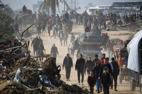Displaced Palestinians walk towards Gaza City as they cross the Netzarim corridor from the southern Gaza Strip on January 27, 2025. 
