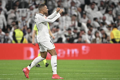 Real Madrid's French forward #09 Kylian Mbappe celebrates scoring their first goal during the Spanish league football match between Real Madrid CF and Club Atletico de Madrid at Santiago Bernabeu Stadium in Madrid on February 8.