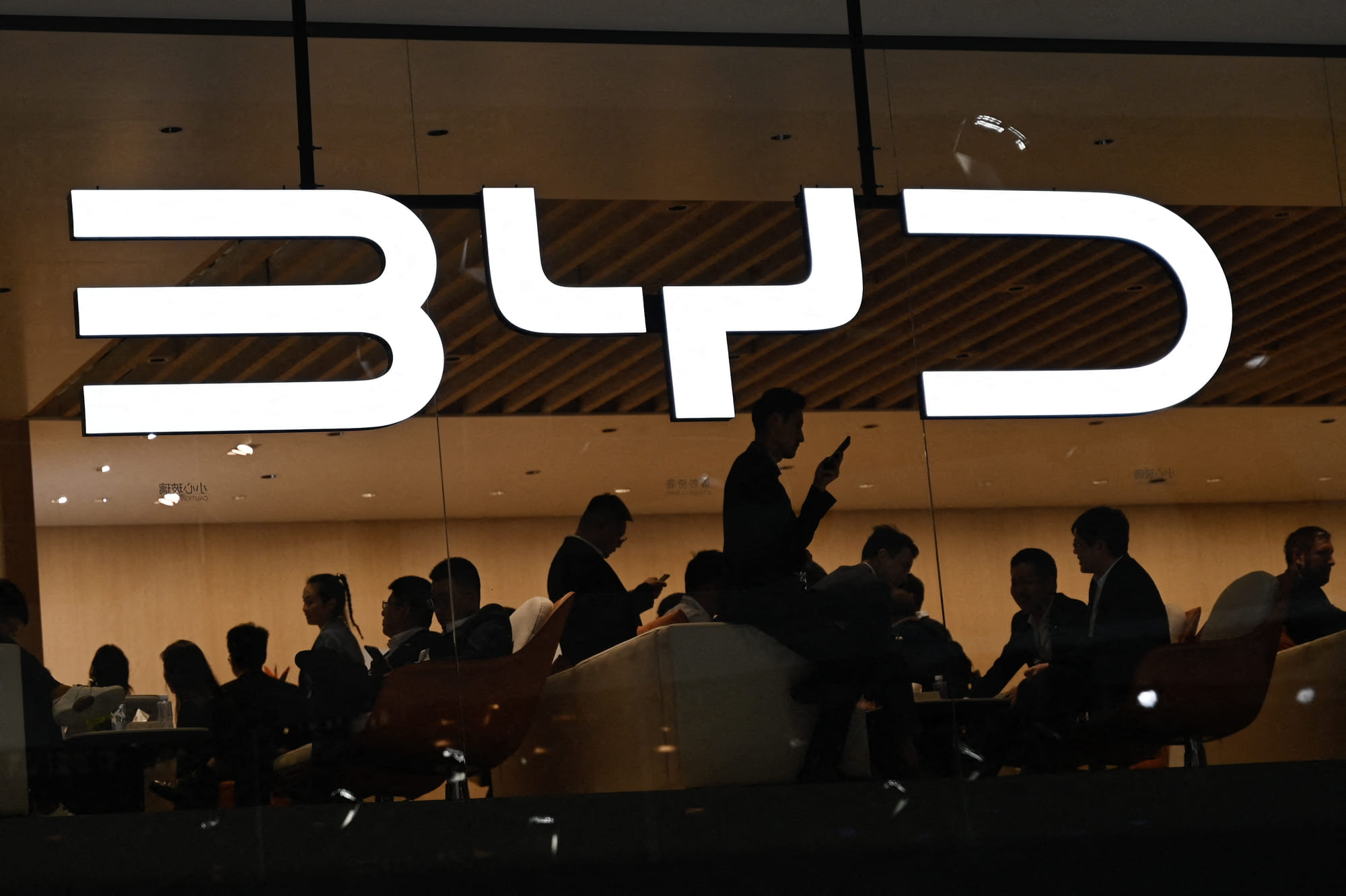 The BYD logo is displayed at the Beijing Auto Show. BYD introduced the Super e-Platform alongside two new EV models that will be the first to feature the system: the Han L sedan and the Tang L SUV.