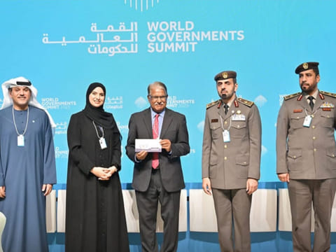 Dr Reza Khan (centre) receiving his Blue Visa at the World Government Summit yesterday.