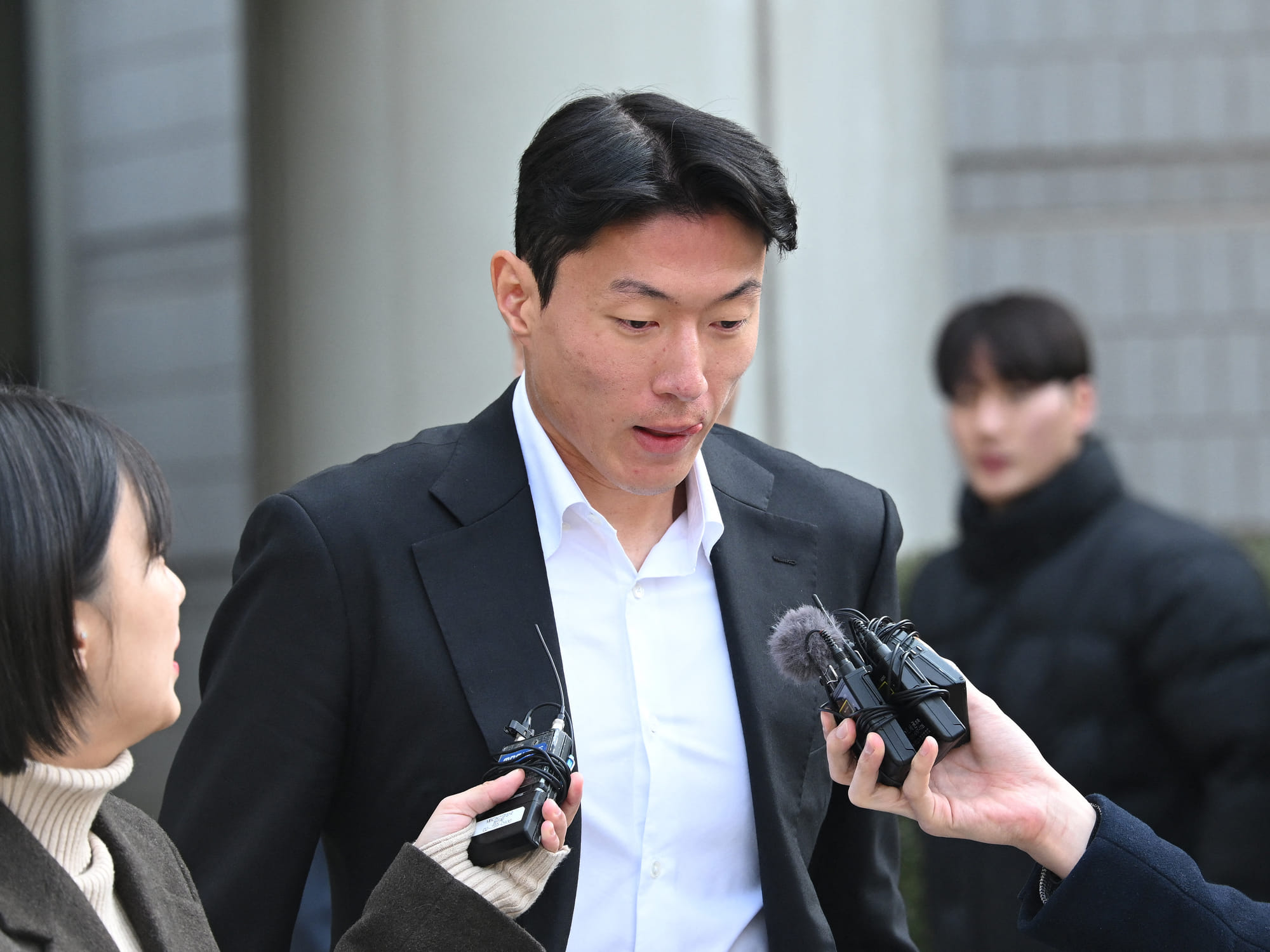 South Korean footballer Hwang Ui-jo leaves after receiving a sentence over his sex-video scandal at the Seoul Central District Court in Seoul on February 14, 2025.