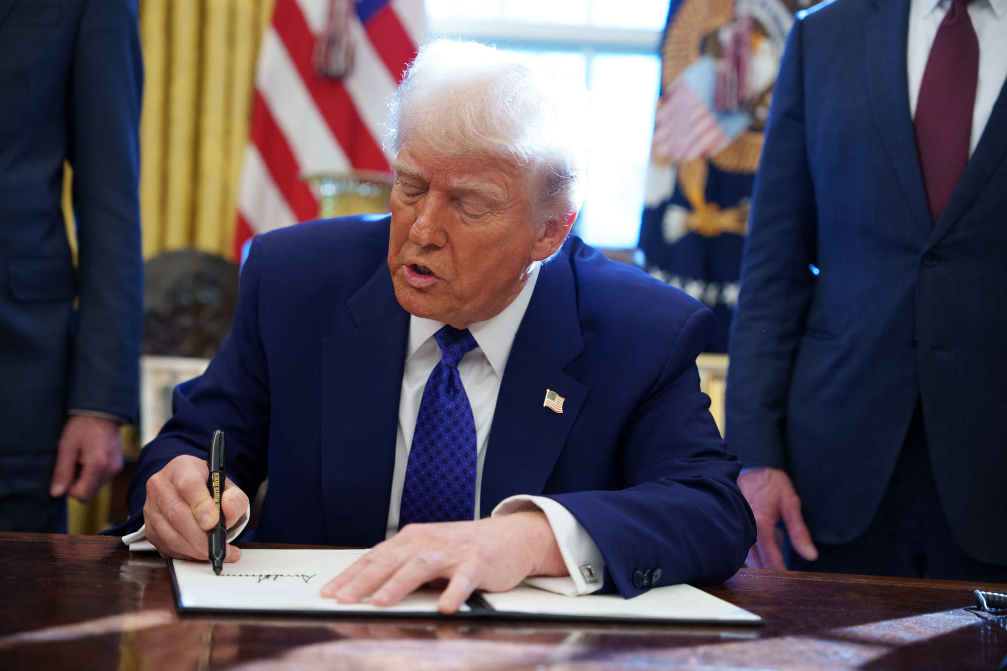 US President Donald Trump signs an executive order establishing the Energy Dominance Council led by Secretary of the Interior Doug Burgum in the Oval Office at the White House on February 14, 2025 in Washington, DC.