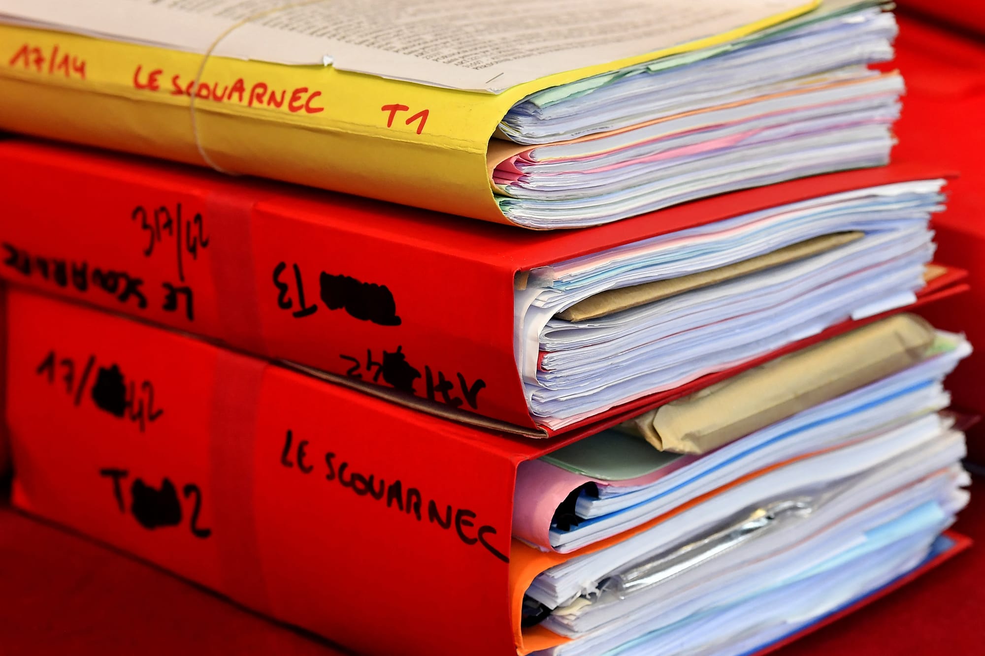 Files are displayed in the courtroom during the opening day of French surgeon Joel Le Scouarnec' s trial for the rape and sexual abuse of four child at the courthouse in Saintes, western France, on March 13, 2020.