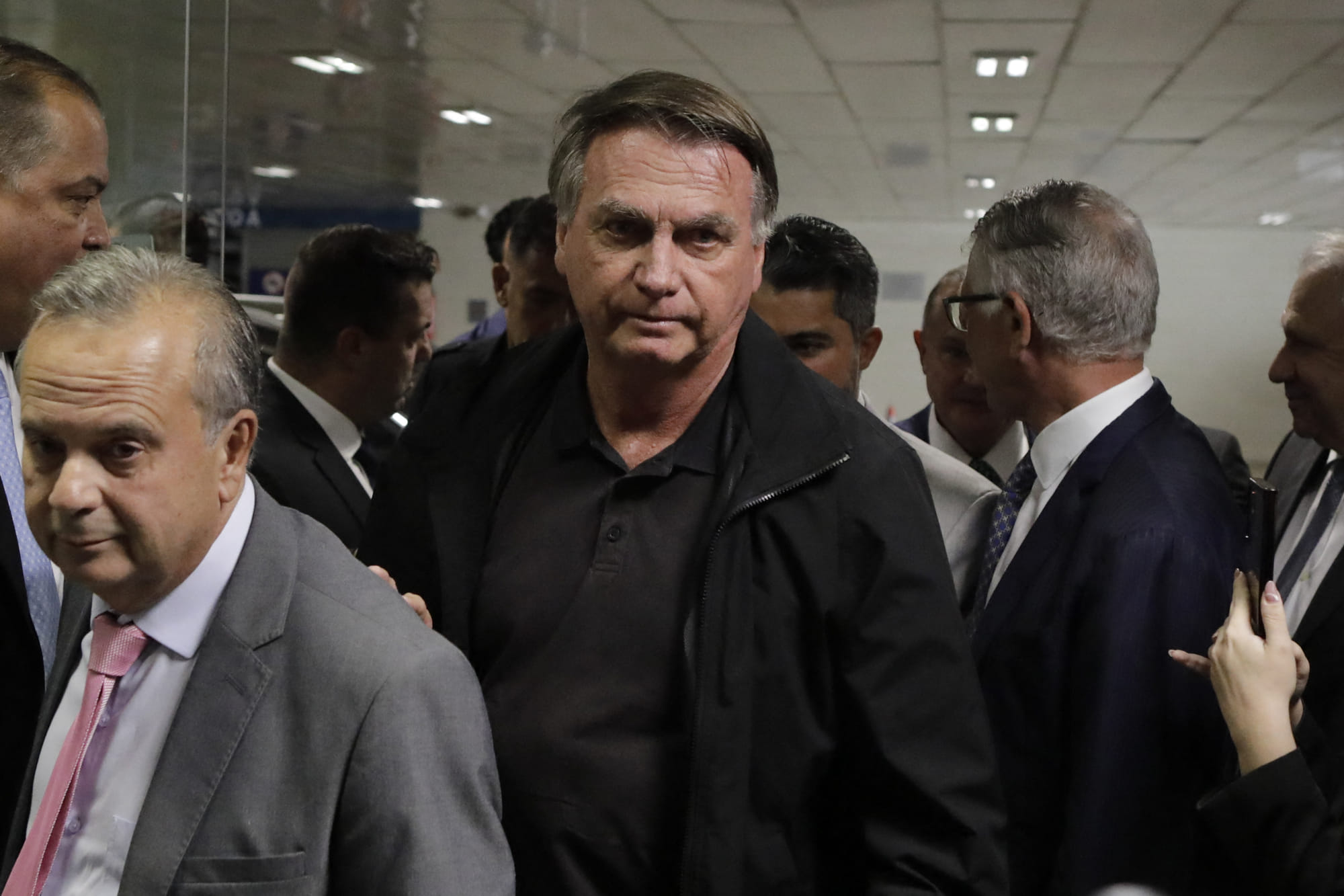 Former Brazil's President Jair Bolsonaro (C) arrives at the Federal Senate to have lunch with leaders of opposition parties in Brasilia on February 18, 2025.