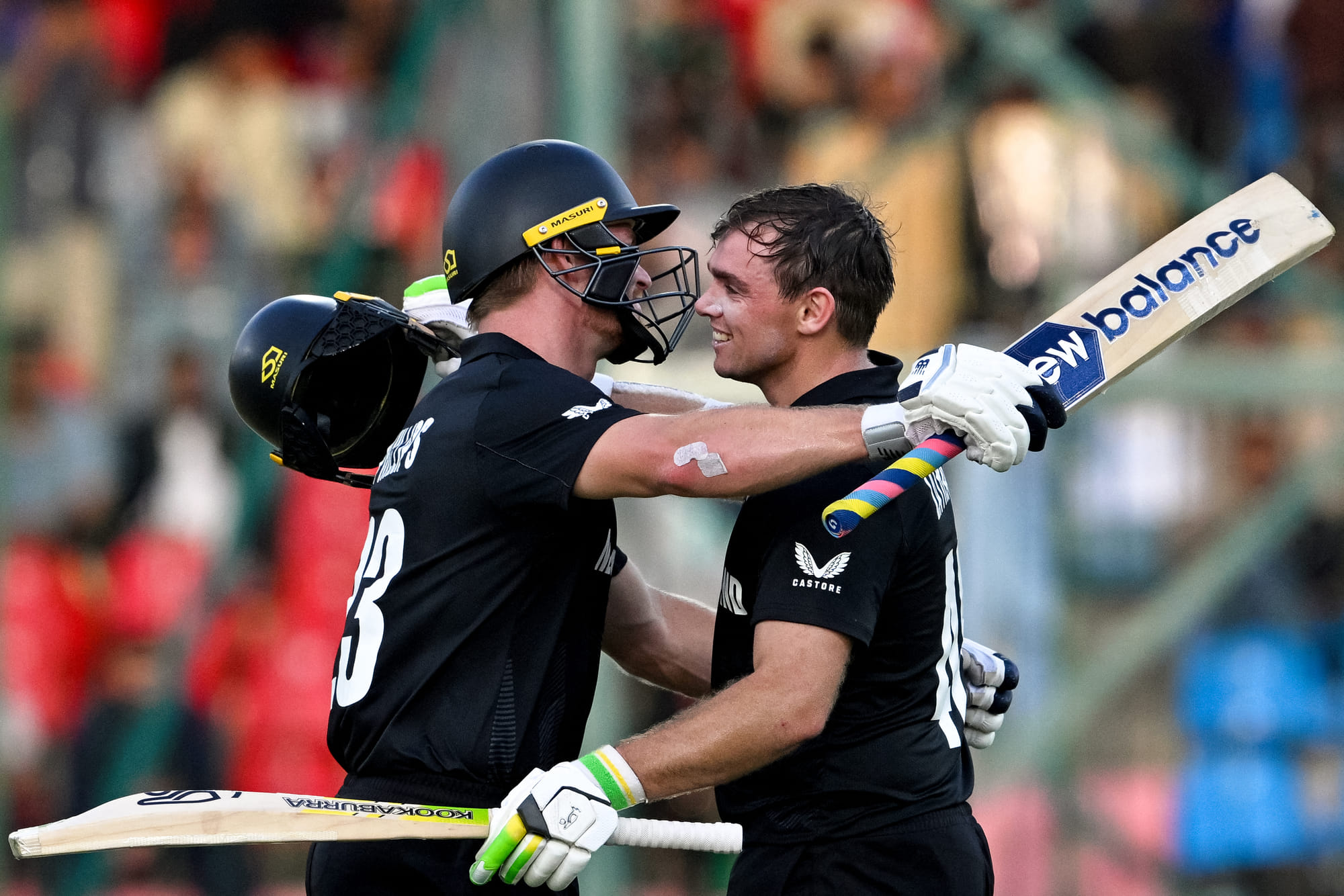 New Zealand's Tom Latham (right) celebrates with Glenn Phillips after scoring a century during the ICC Champions Trophy cricket against Pakistan at the National Stadium in Karachi on February 19.