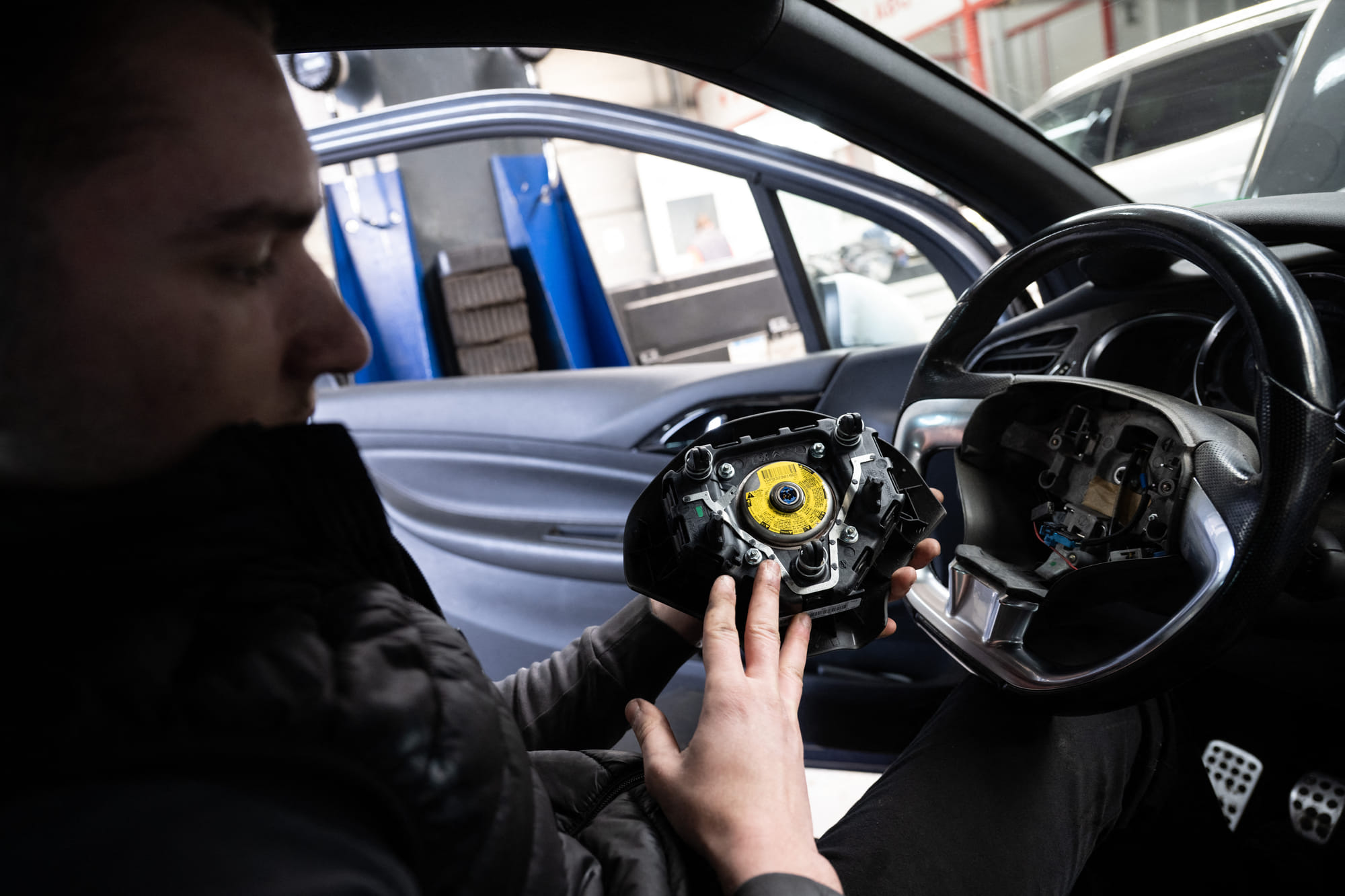 A mechanic removes from a car an airbag module made by the Japanese airbag manufacturer Takata, in a garage in Mulhouse, eastern France, on February 19, 2025.