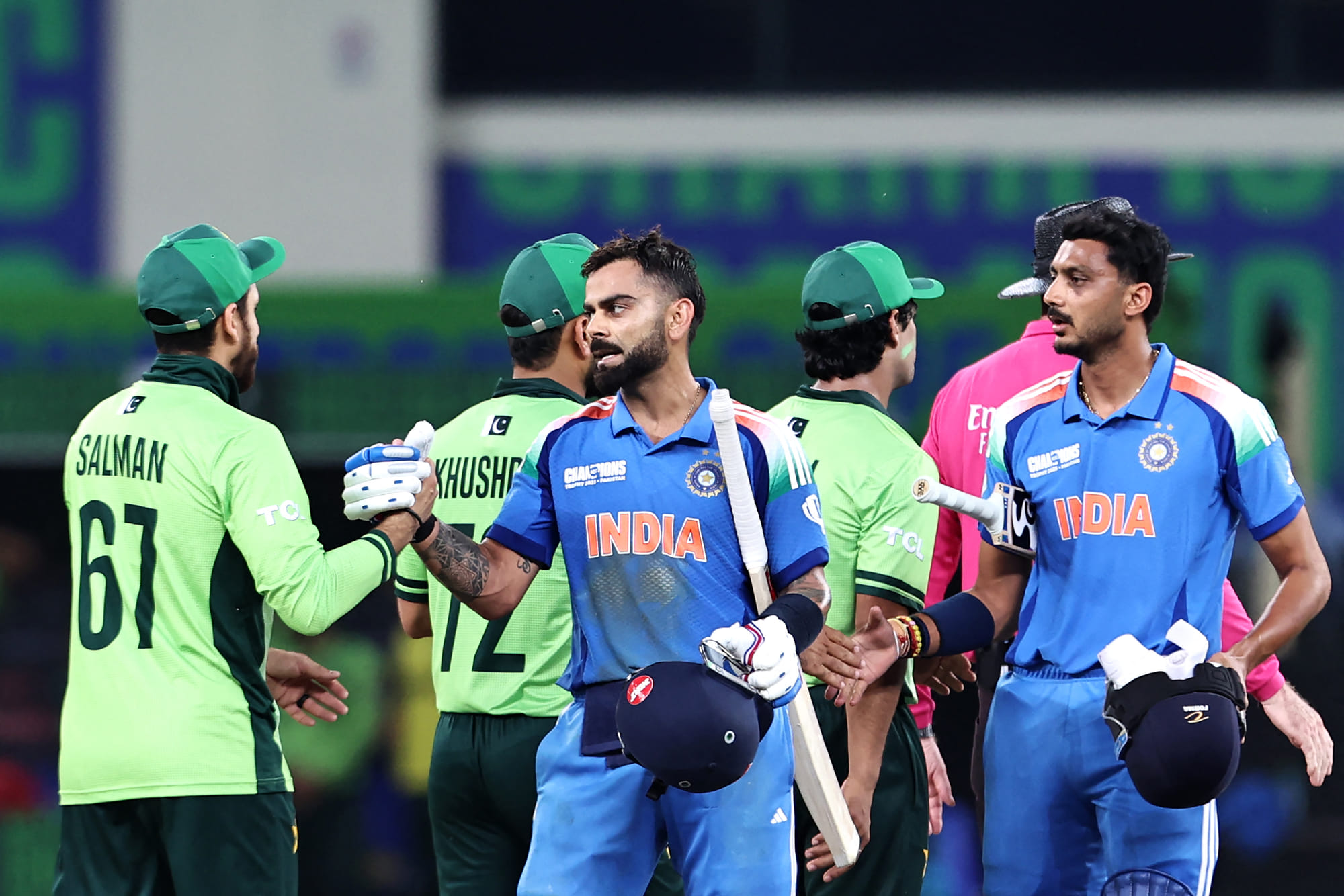 India's Virat Kohli and Axar Patel shake hands with Pakistan's players after winning the Champions Trophy match in Dubai on February 23. The two teams will be facing each other on September 14 with another two potential contests during Asia Cup.