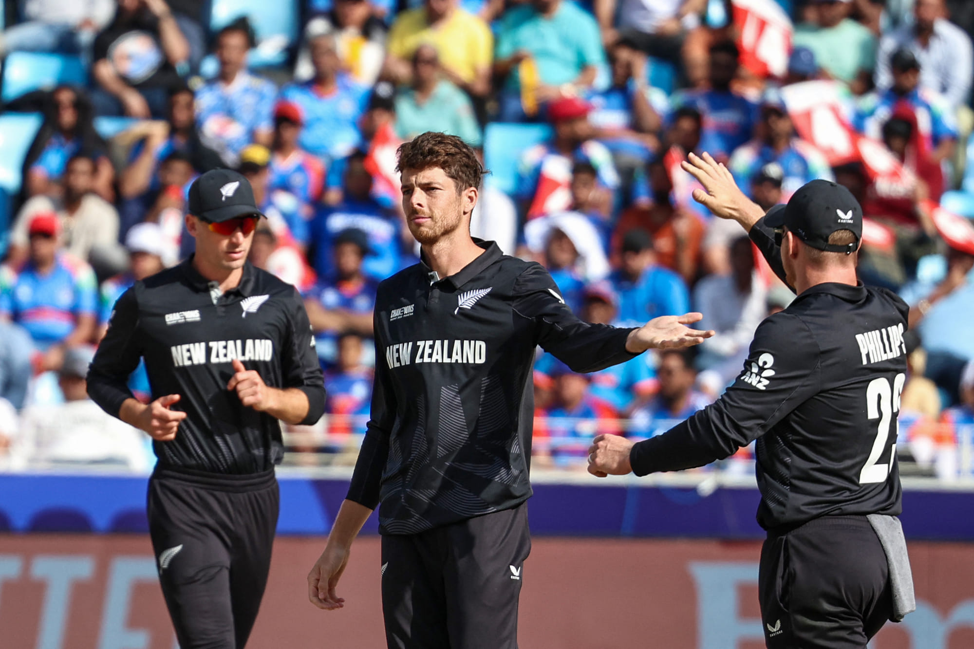 New Zealand's captain Mitchell Santner (C) celebrates with teammates after dismissing India's KL Rahul during the ICC Champions Trophy One-Day International (ODI) cricket match at the Dubai International Stadium in Dubai on March 2.