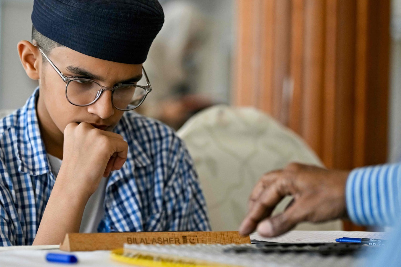 Pakistani prodigy Bilal Asher, world under-14 Scrabble champion, competes against professional Scrabble coach Waseem Khatri during an event organised by the Pakistan Scrabble Association (PSA) at the Beach Luxury hotel in Karachi.  