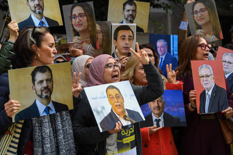 Relatives of detainees accused of involvement in a conspiracy case against state security, gesture on the day of a first hearing in front of the court in Tunis on March 4, 2025.  