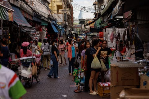 Shoppers at a market in Bangkok. About 2.7 million beneficiaries in the age group will receive 10,000  baht ($295.82) each, with the disbursement set to be made through a new “digital wallet” application meant to boost spending.
