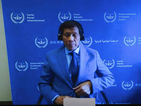 Former Philippine President Rodrigo Duterte is seen on a screen in the courtroom during his first appearance before the ICC, March 14, 2025.