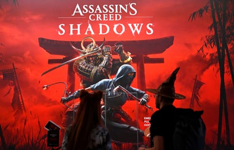 Visitors stand at the 'Assassin's Creed Shadows' video game booth by Ubisoft during the media day at the Gamescom video games trade fair in Cologne, western Germany on August 21, 2024.