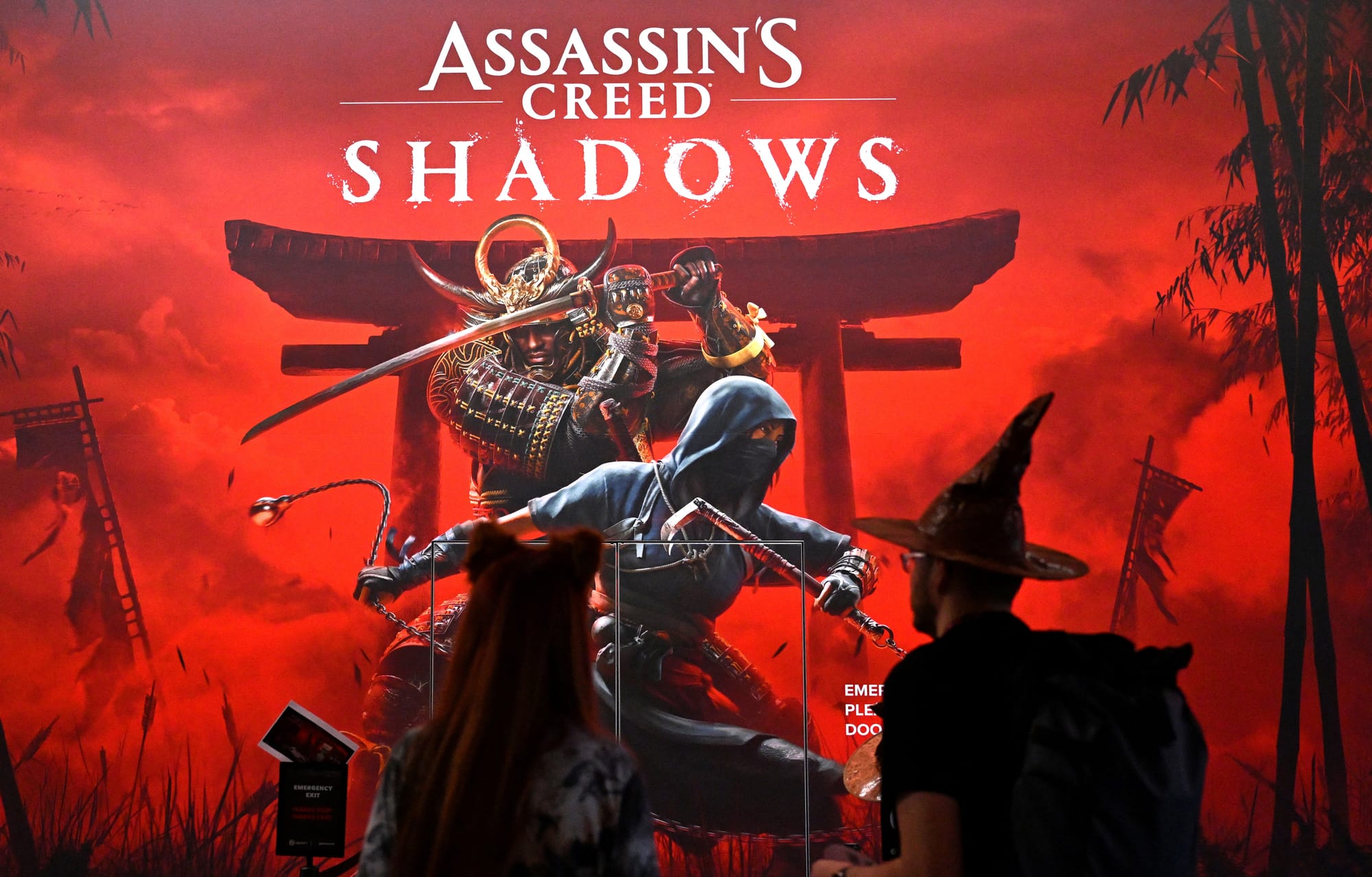 Visitors stand at the 'Assassin's Creed Shadows' video game booth by Ubisoft during the media day at the Gamescom video games trade fair in Cologne, western Germany on August 21, 2024.
