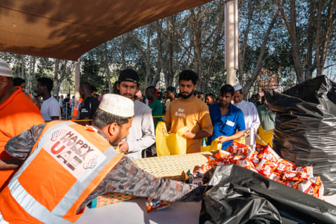 Thanks to two Malawian brothers in Dubai, hundreds of constructions workers are provided Iftar under the 'Happy Happy' initiative in Dubai during Ramadan. seen above are volunteers distributing the free meals at a DIP camp. 