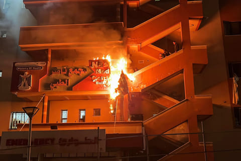 Palestinians try to put out a fire at the emergency department of the Nasser hospital after it was hit in an Israeli airstrike, in Khan Yunis in the southern Gaza Strip on March 23, 2025. 