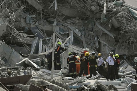 Rescue teams are seen at a construction site where a building collapsed in Bangkok on March 28, 2025, after an earthquake. A powerful earthquake rocked central Myanmar on March 28, buckling roads in the capital Naypyidaw, damaging buildings and forcing people to flee into the streets in neighbouring Thailand.
