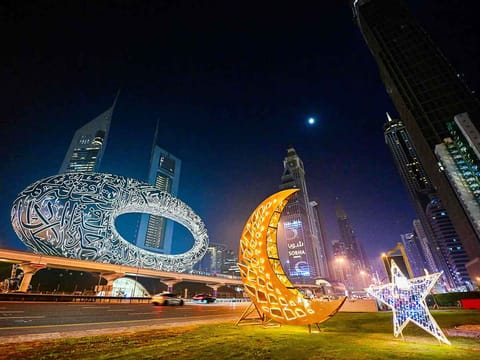 Motorists drive past roadside decorations installed near the Museum of the Future in Dubai. 