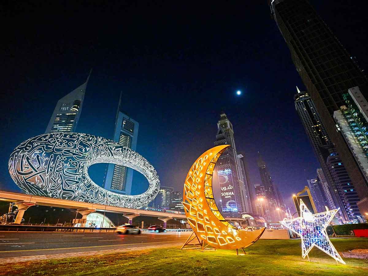 Motorists drive past roadside decorations installed near the Museum of the Future in Dubai. 