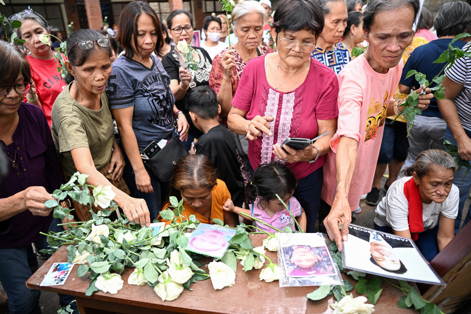Families of victims of former Philippines president Rodrigo Duterte's "war on drugs" take part in a thanksgiving mass at a church in Manila on March 31, 2025, weeks after Duterte was arrested and brought to the International Criminal Court (ICC) in The Hague.