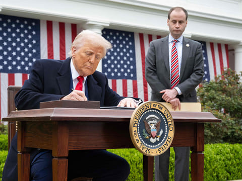 US President Donald Trump signs an executive order after delivering remarks on reciprocal tariffs during an event in the Rose Garden entitled "Make America Wealthy Again" at the White House in Washington, DC.