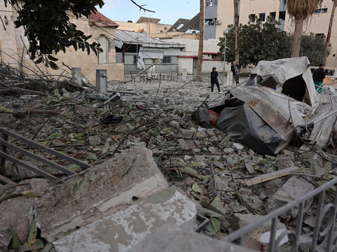 People check the destruction in the aftermath of an Israeli strike on the Al Ahli hospital, also known as the Baptist or Ahli Arab hospital, in Gaza City on April 13, 2025. 