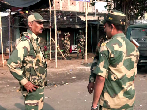 Security personnel stand guard after violent protests against the Waqf (Amendment) Act, at Dhuliyan in Murshidabad on Saturday, April 12, 2025. 