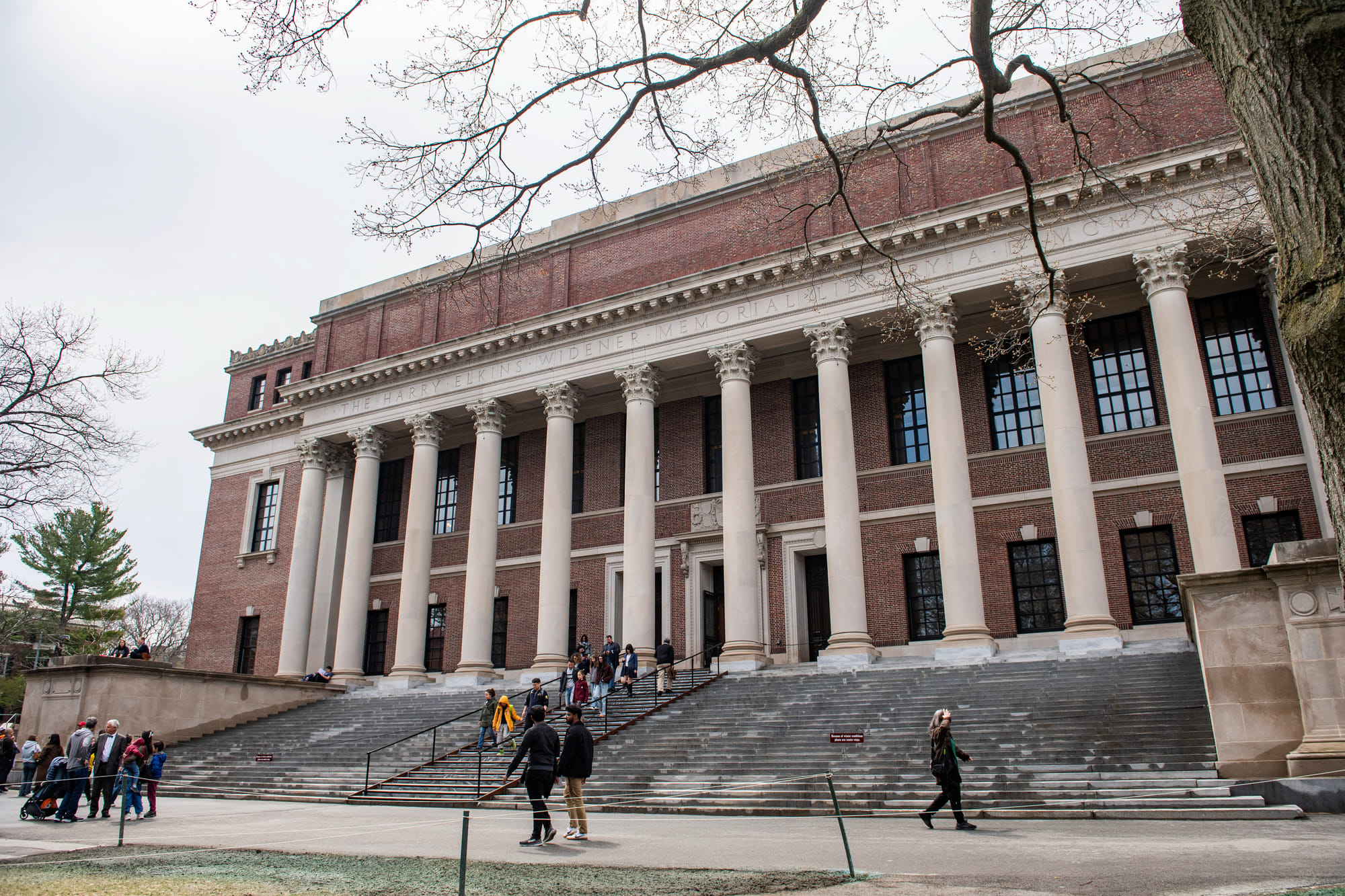 People enter and exit the Harry Elkins Widener Memorial Library on the Harvard University campus in Cambridge, Massachussetts, on April 15, 2025.