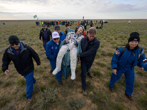 NASA astronaut Don Pettit (C)  being carried to a medical tent shortly after he, and Roscosmos cosmonauts Alexey Ovchinin and Ivan Vagner landed in their Soyuz MS-26 spacecraft near the town of Zhezkazgan, Kazakhstan.