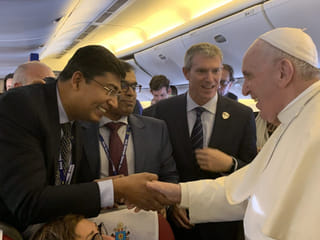 When Pope Francis walked down the aisle and clasped my hand