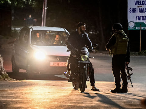 An Indian Army personnel stops vehicles for inspection near Pahalgam, south of Srinagar, following an attack.