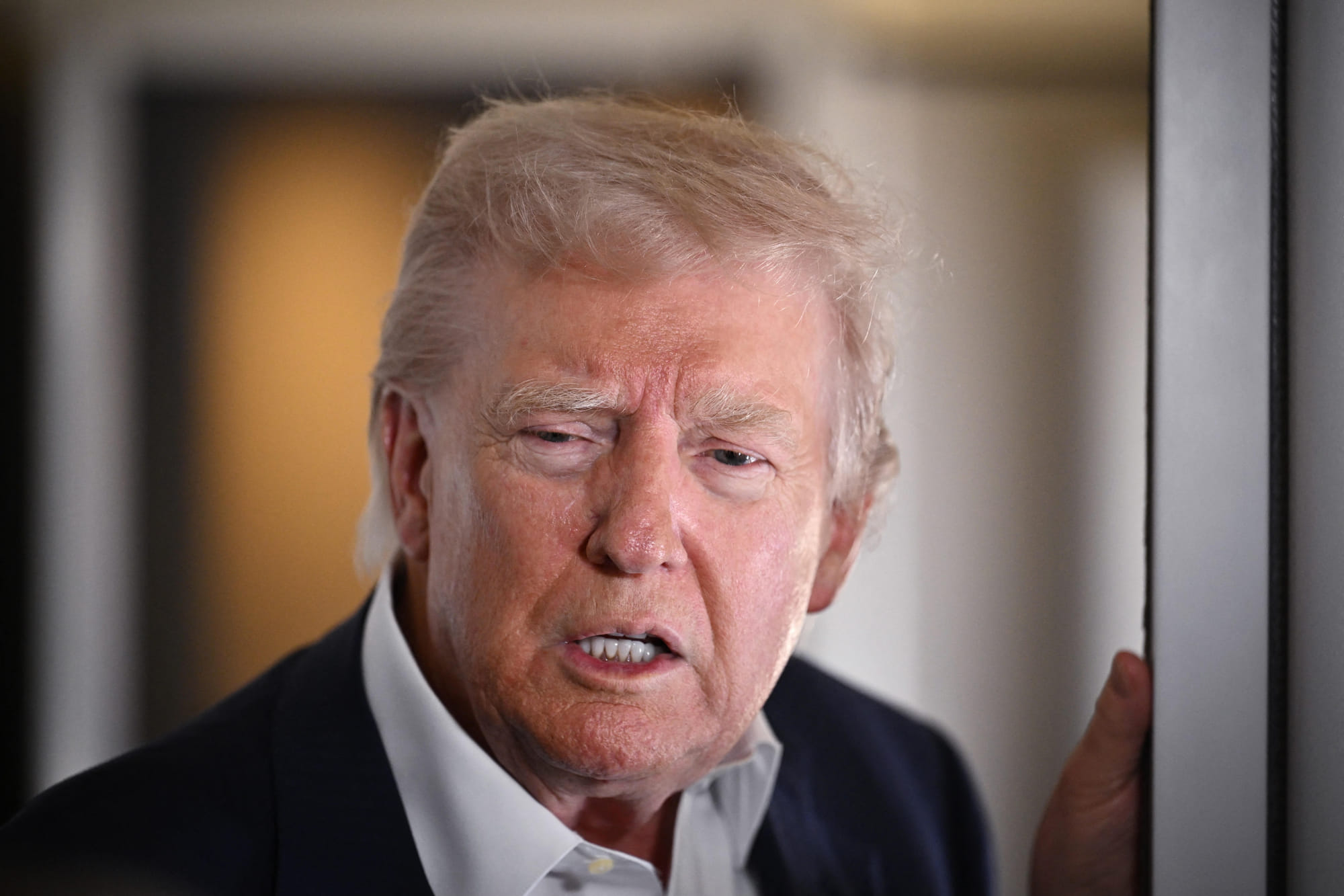 US President Donald Trump speaks to reporters while in flight on Air Force One, en route to Rome, Italy on April 25, 2025.