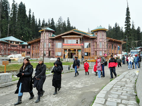Tourists take a stroll after taking a Gondola Ride at the Gulmarg Ski Resort, days after the Pahalgam terror attack that left 26 tourists dead, in Gulmarg on Saturday. 