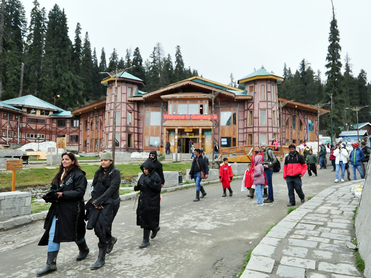 Tourists take a stroll after taking a Gondola Ride at the Gulmarg Ski Resort, days after the Pahalgam terror attack that left 26 tourists dead, in Gulmarg on Saturday. 