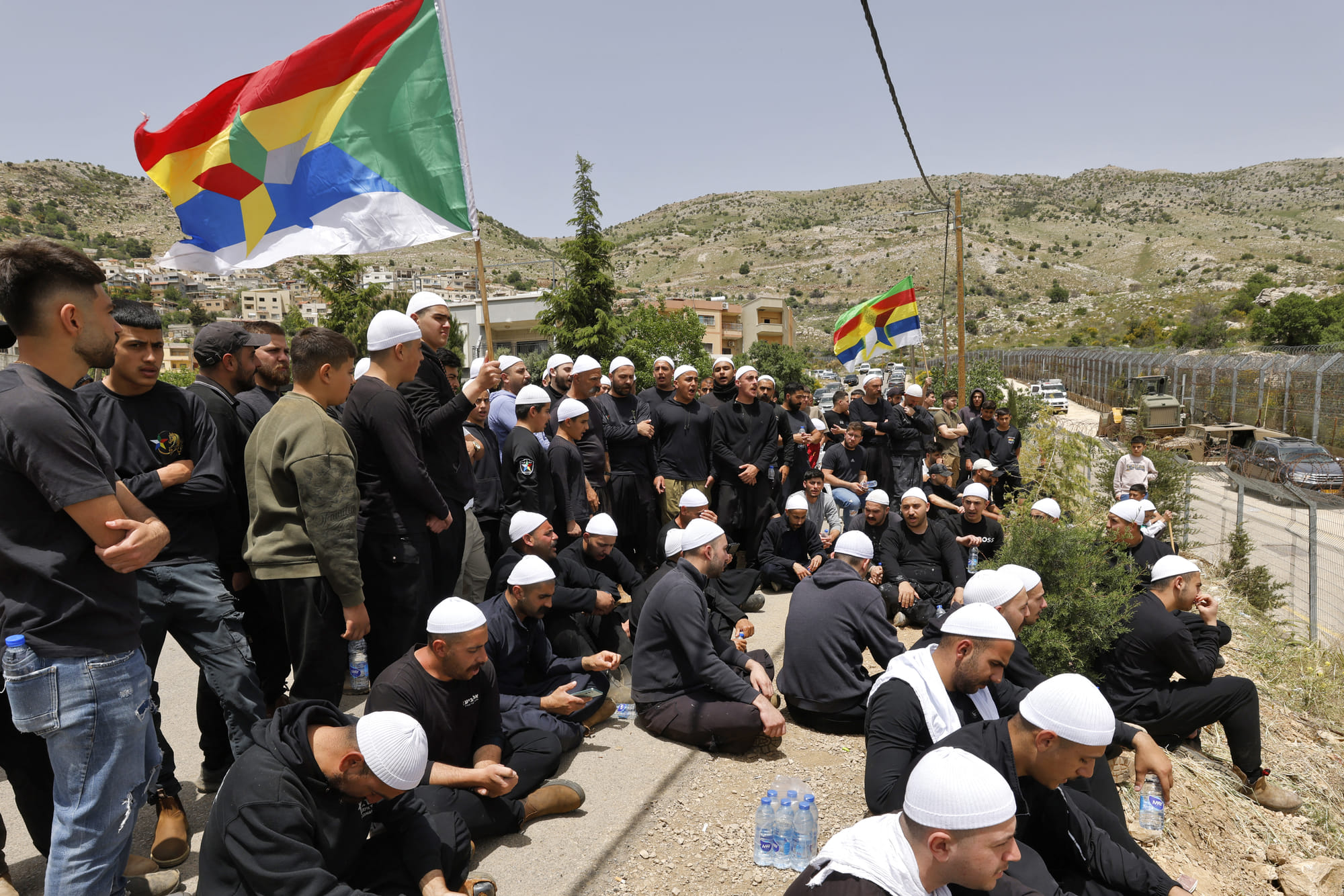 Druze men demonstrate in solidarity with the Syrian Druze community near the border barrier in the village of Majdal Shams in the Israeli-annexed Golan Heights on April 30, 2025.