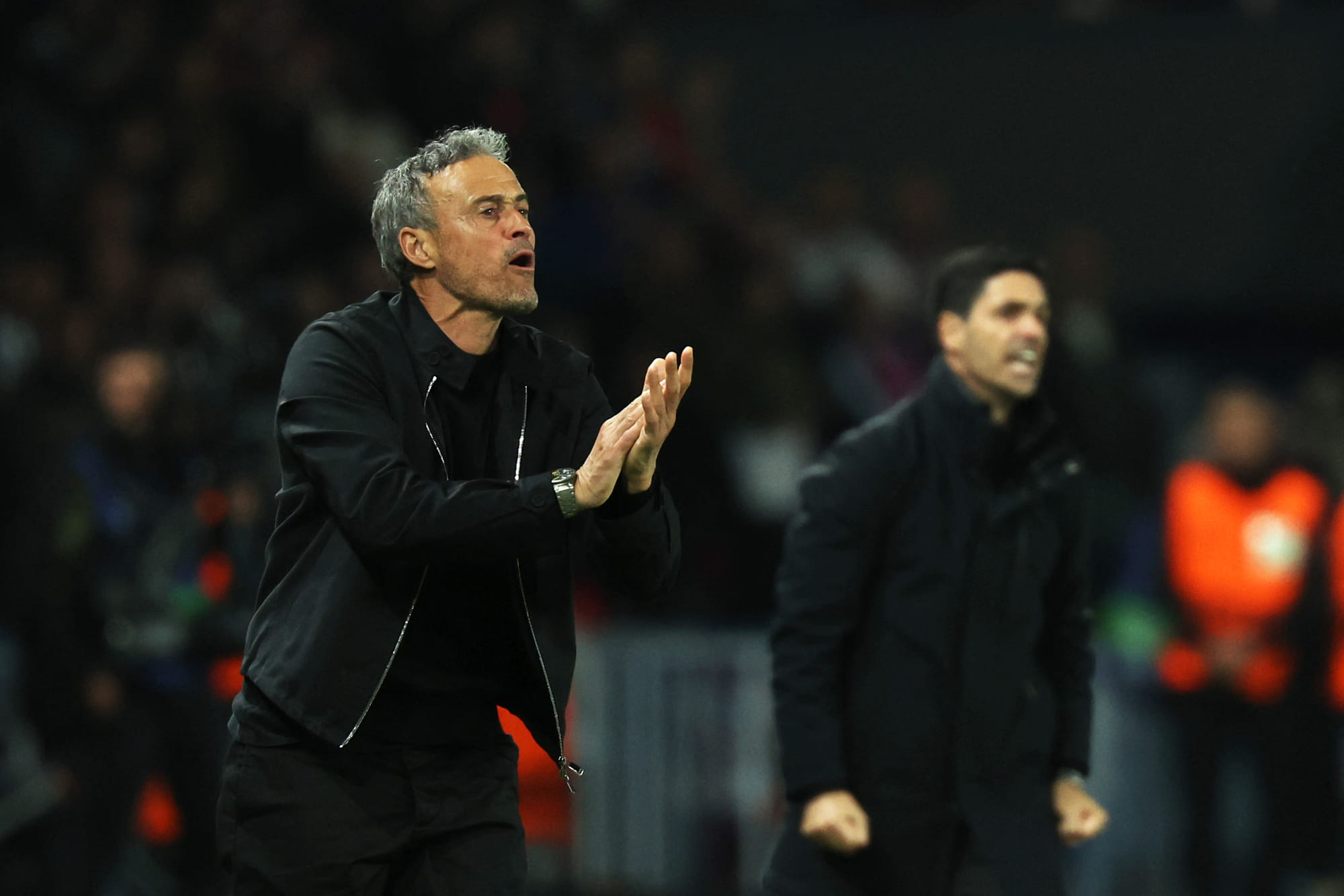 Paris Saint-Germain's Spanish coach Luis Enrique (L) reacts next to Arsenal's Spanish coach Mikel Arteta (R) during the UEFA Champions League semi-final second leg football match, on May 7, 2025.