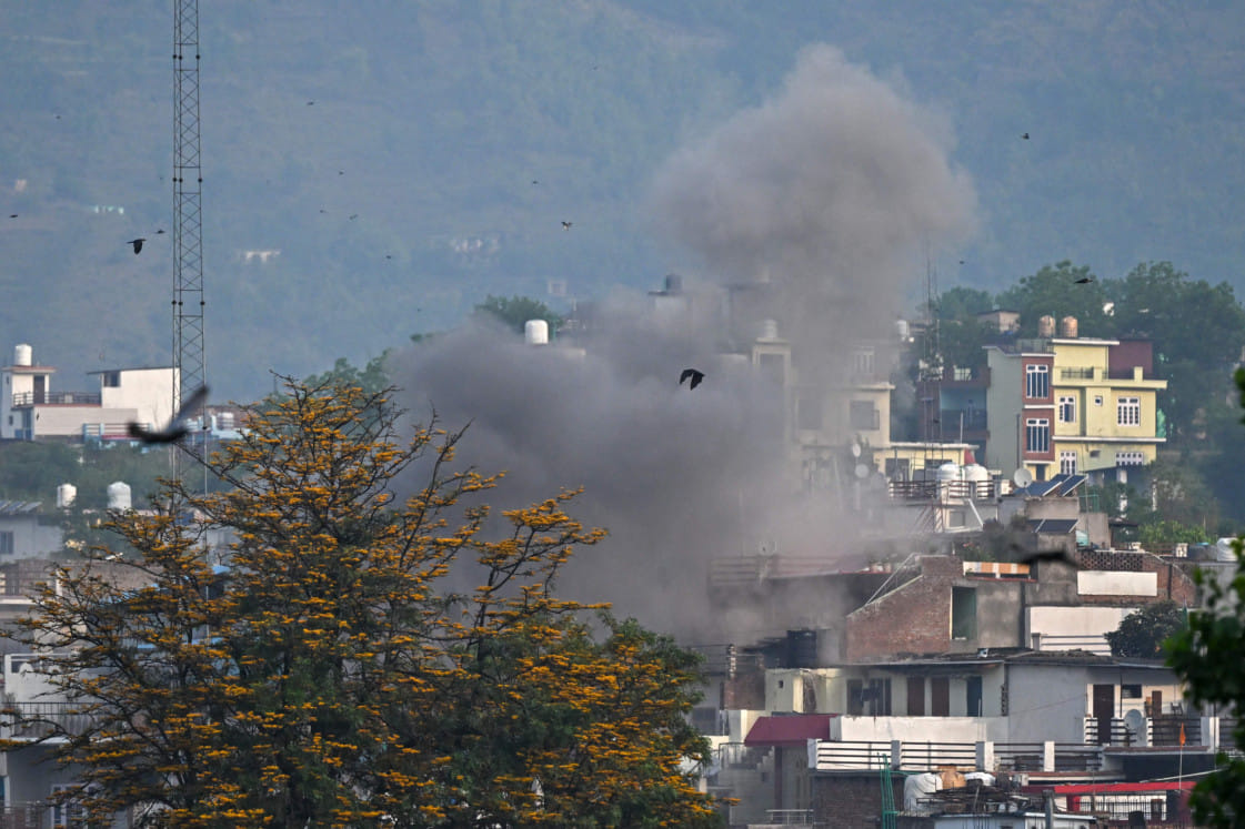 Smoke billows after an artillery shell landed in the main town of Poonch district in India's Jammu region on May 7.
