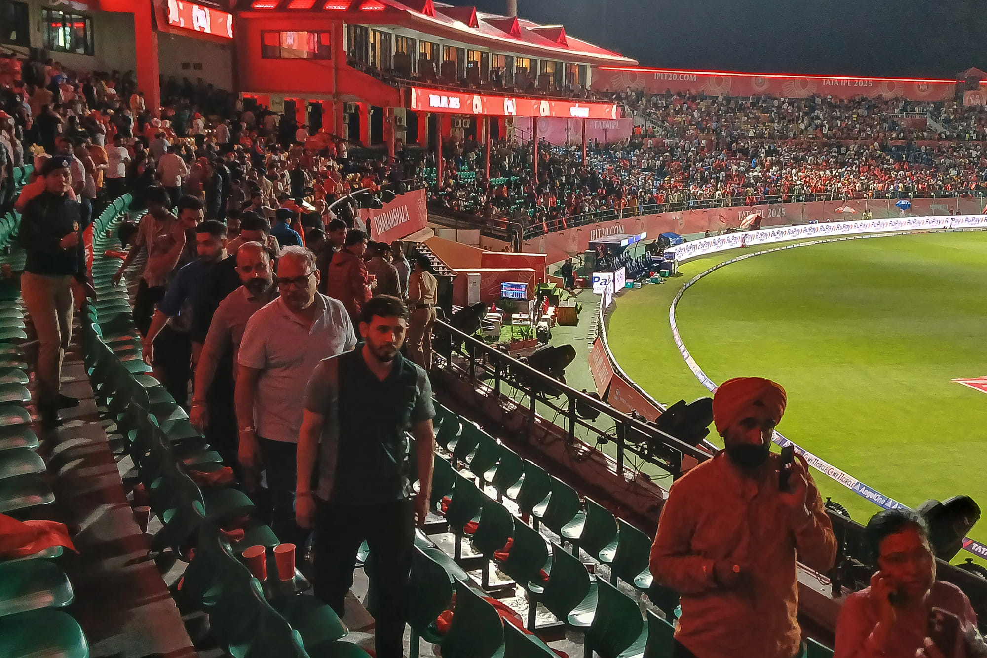 Spectators leave after the Indian Premier League (IPL) Twenty20 cricket match between Punjab Kings and Delhi Capitals was abandoned due to a significant technical failure at the Himachal Pradesh Cricket Association Stadium in Dharamsala on May 8.