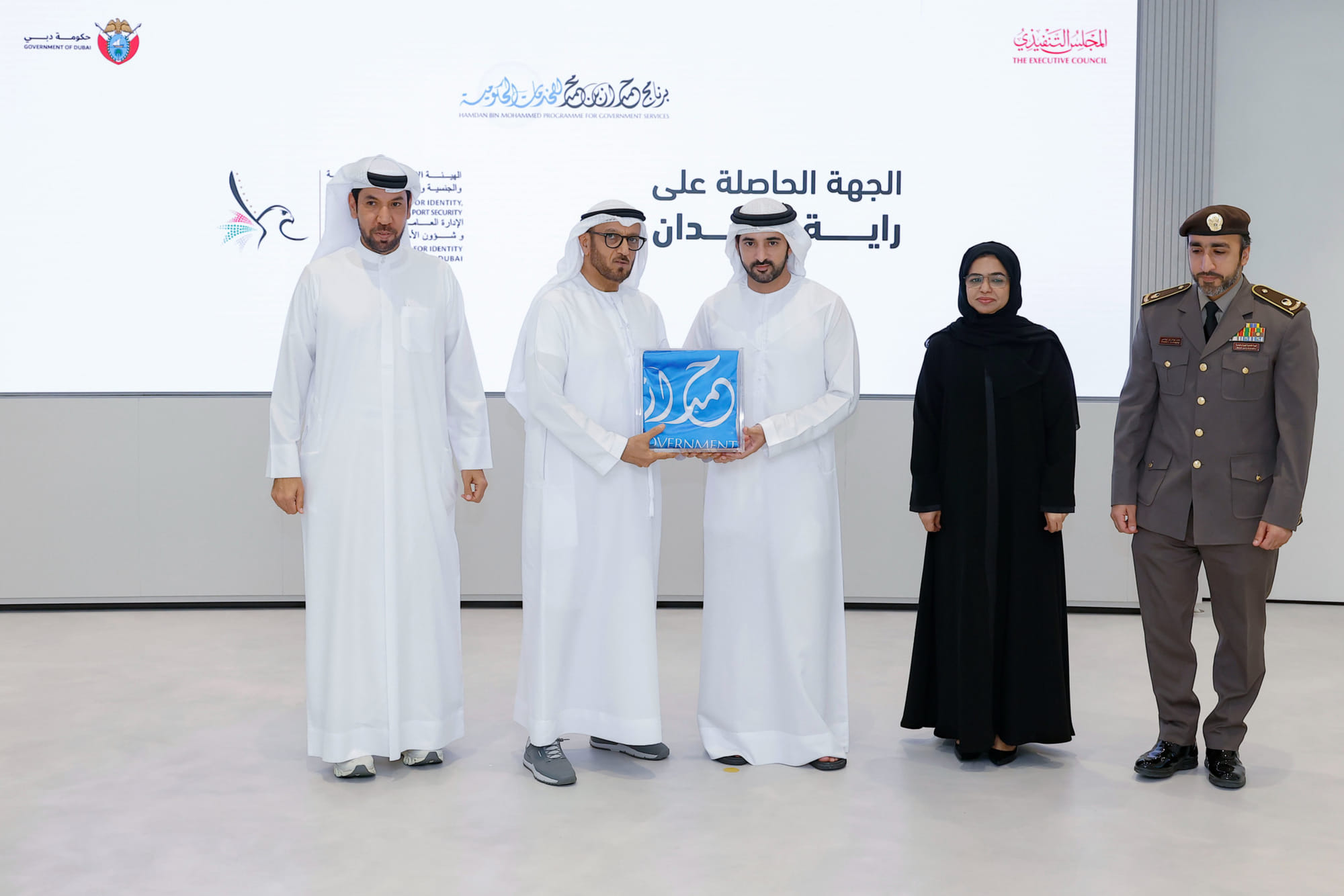 Sheikh Hamdan bin Mohammed bin Rashid Al Maktoum giving Hamdan Flag to Lt Gen Mohammed Ahmed Al Marri, Director General of the GDRFA at a ceremony in Dubai