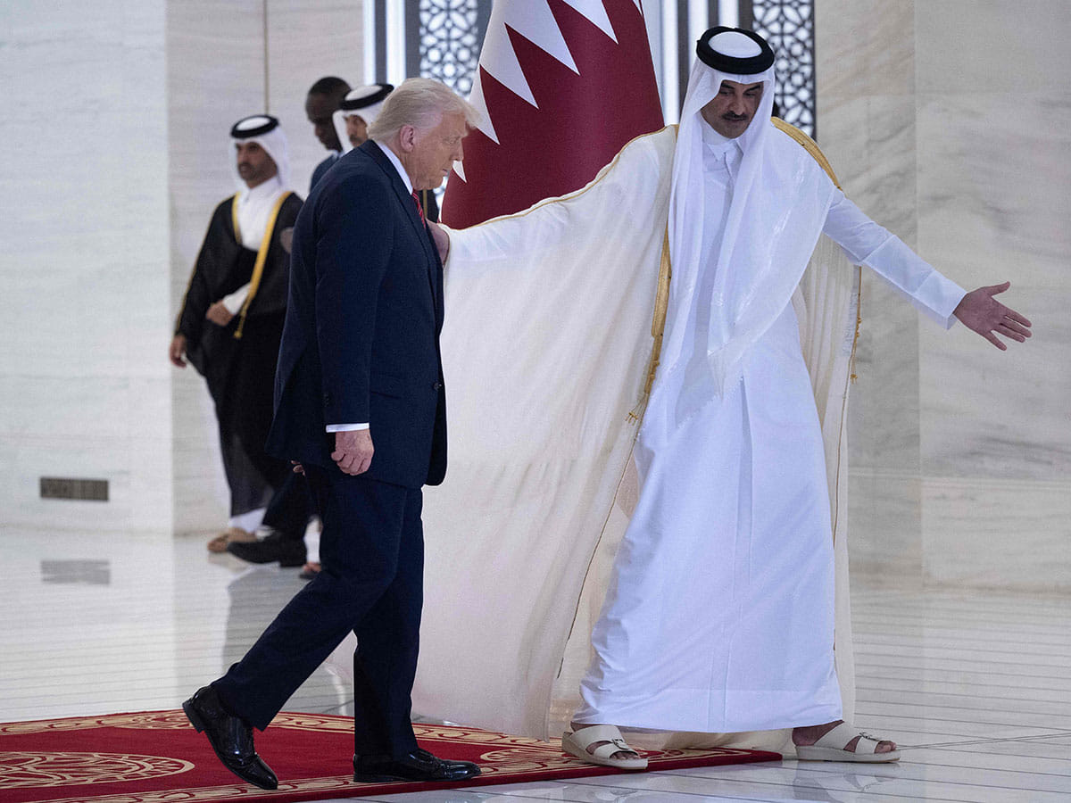 Qatar's Emir Sheikh Tamim bin Hamad Al Thani receives US President Donald Trump in the Qatari capital Doha on May 14, 2025.  