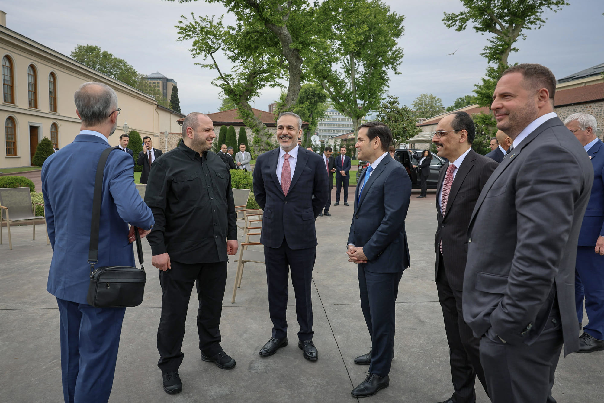 This handout photograph taken and released by Turkish Foreign Ministry on May 16, 2025, shows Turkey's Foreign Minister Hakan Fidan (3rd L), US Secretary of State Marco Rubio (4th L), Ukraine's Head of the Office of the President Andriy Yermak (R), Ukraine's Defence Minister Rustem Umerov (2nd L) and Turkish Intelligence Organization Director Ibrahim Kalin (2nd R) chatting at the backyard of the Turkish Presidential office Dolmabahce, in Istanbul, ahead their meeting for Ukraine-Russia peace talks.