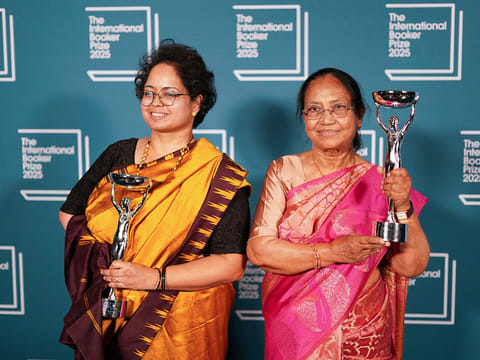 Banu Mushtaq, author of 'Heart Lamp', right, and Deepa Bhasthi hold the trophies after winning the International Booker Prize, in London.