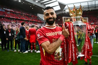 Liverpool's Egyptian striker #11 Mohamed Salah celebrates with the Premier League trophy at the end of the English Premier League football match between Liverpool and Crystal Palace at Anfield in Liverpool, north west England on May 25, 2025.
