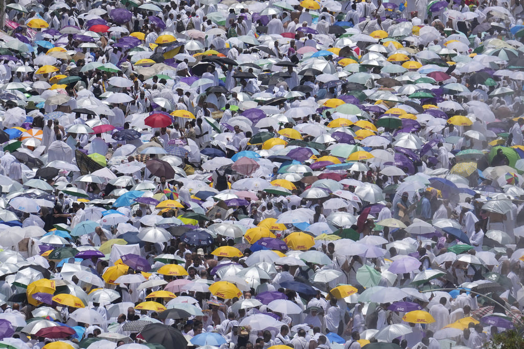 Muslim pilgrims use umbrellas to shield themselves from the sun as they gather outside Nimrah Mosque to offer the noon prayers in Arafat, on the second day of the annual hajj pilgrimage, near the holy city of Mecca, Saudi Arabia, Saturday, June 15, 2024. 