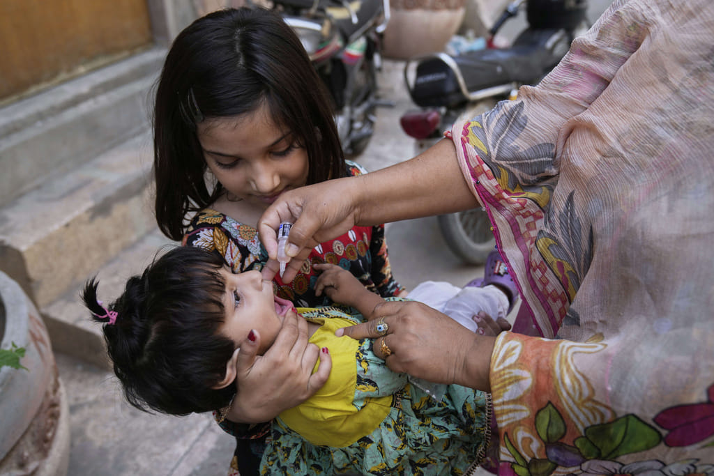 A health worker administers a polio vaccine to a child at a neighbourhood, in Lahore, Pakistan, Monday, May 26, 2025. 