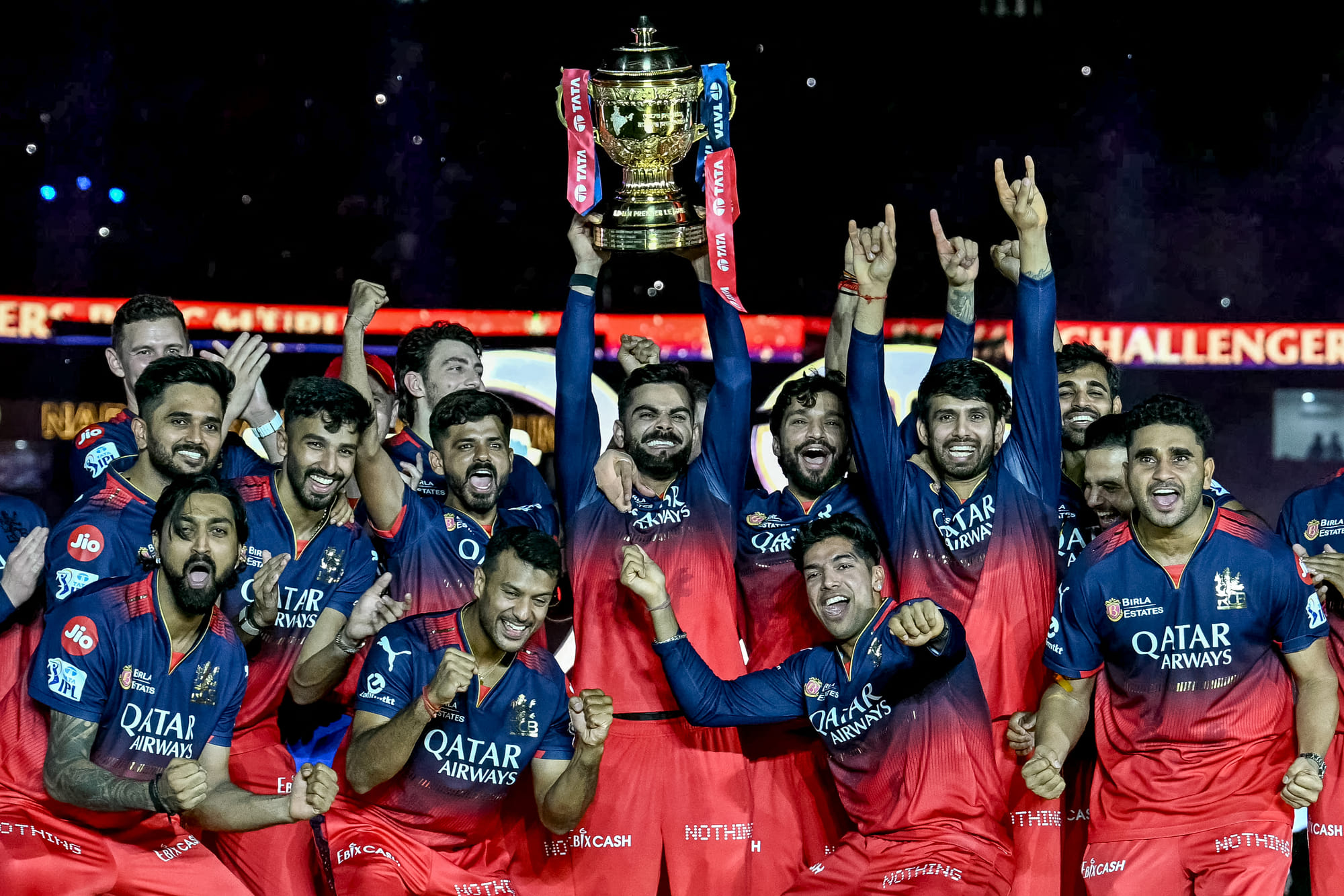 Royal Challengers Bengaluru's Virat Kohli (centre), along with his teammates, celebrates with the trophy after winning the Indian Premier League final.
